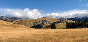 Photograph of hilly land near mountains (JPG file, 93 KB). 