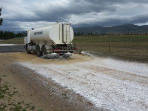 Photograph of application of copolymer to haul road. 
