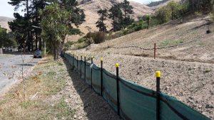 Silt fence installed across a loess hill slope in the Port Hills.