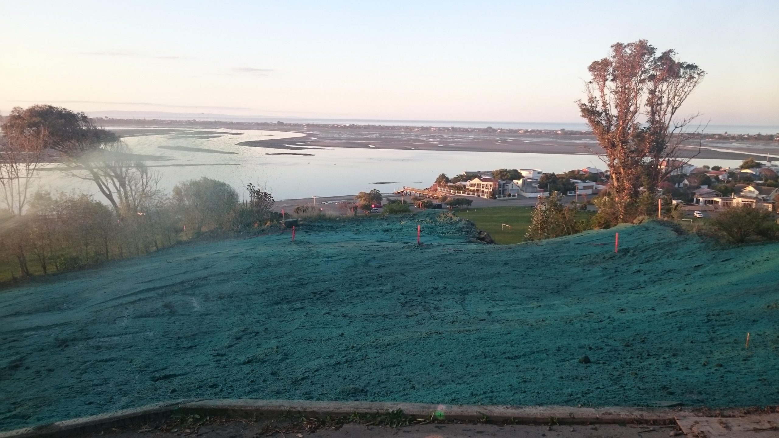A well protected site where soil binding co-polymer was applied to significantly reduce erosion risk. The Estuary of the Avon and Heathcote Rivers / Ihutai is protected from sediment runoff from this site (Source: RST Solutions Limited).